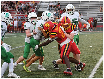A group of football players on a field. Description generated by AI