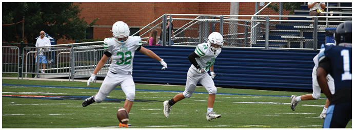 A football player wearing a blue and white uniform. Description generated by AI
