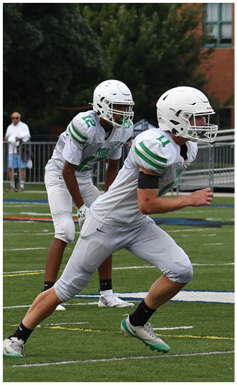 A football player catching a ball. Description generated by AI