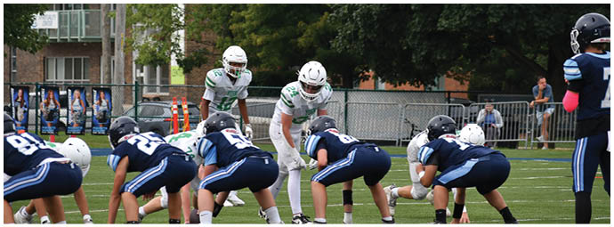 A football player wearing a blue and white uniform. Description generated by AI