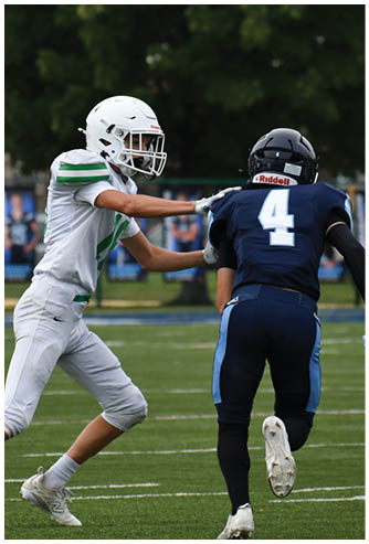 A football game is being played on a field. Description generated by AI