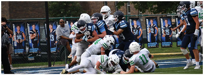 A football player wearing a blue and white uniform. Description generated by AI