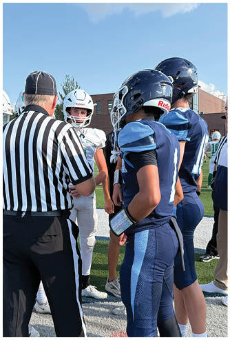 A football game is being played on a field. Description generated by AI