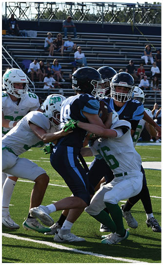A football player catching a ball. Description generated by AI