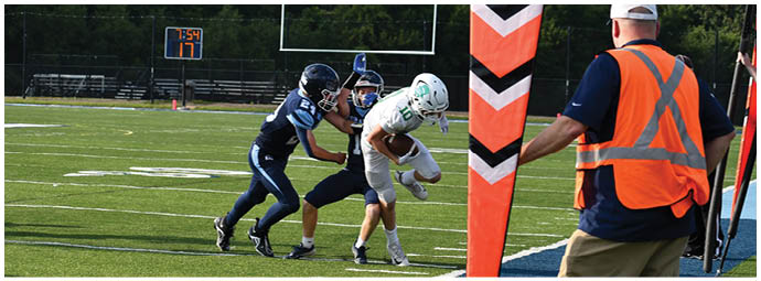 A football player wearing a blue and white uniform. Description generated by AI