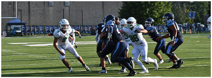 A football player wearing a blue and white uniform. Description generated by AI