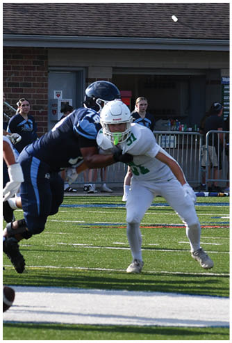 A football game is being played on a field. Description generated by AI