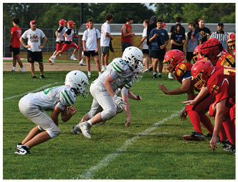 A group of football players on a field. Description generated by AI