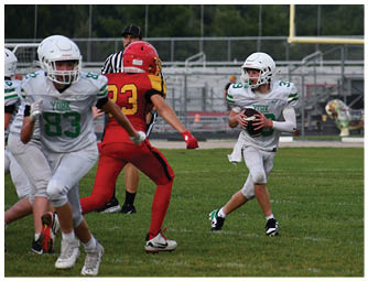 A group of football players on a field. Description generated by AI