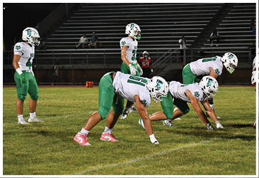 Two football players celebrating on the field. Description generated by AI