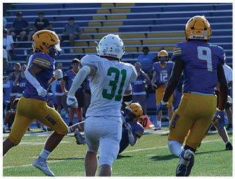 A group of football players on a field. Description generated by AI