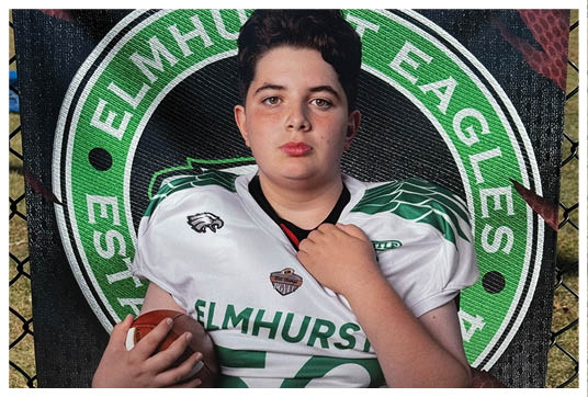 A football player wearing a blue and red jersey. Description generated by AI