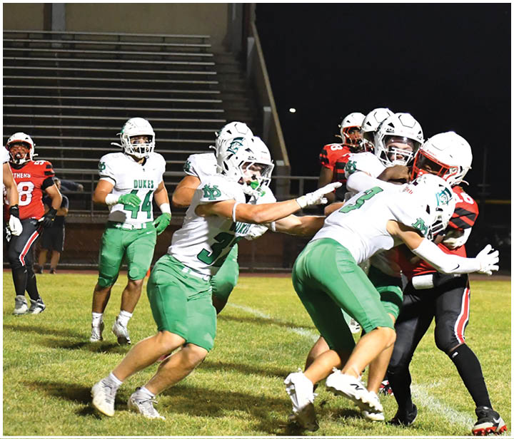 A group of football players on a field. Description generated by AI