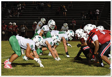 Two football players celebrating on the field. Description generated by AI