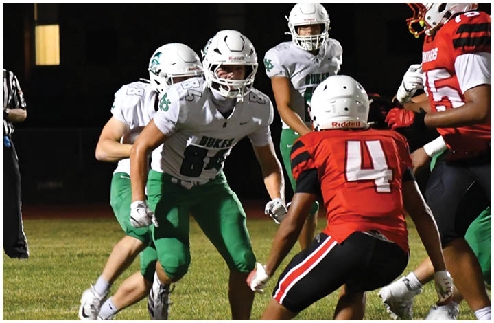 A group of football players on a field. Description generated by AI