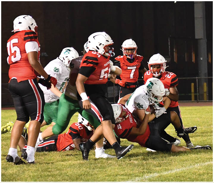 A group of football players on a field. Description generated by AI