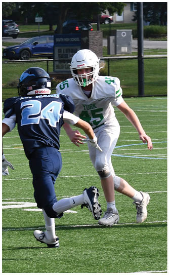 A football player catching a ball. Description generated by AI
