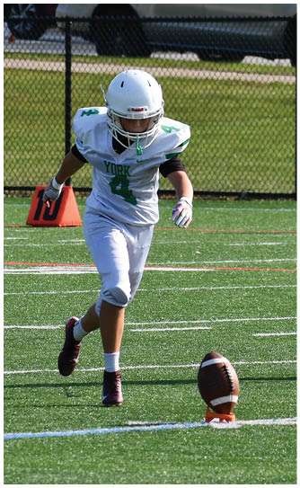 A football player catching a ball. Description generated by AI