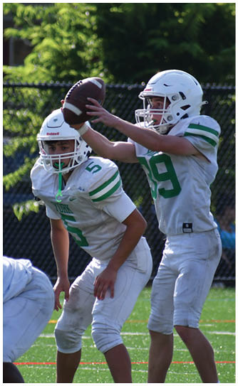 A football player catching a ball. Description generated by AI