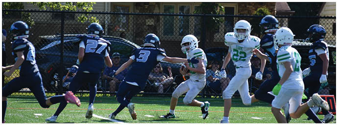A football player wearing a blue and white uniform. Description generated by AI