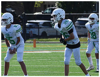 A group of football players on a field. Description generated by AI