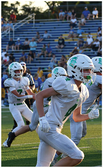 A football player catching a ball. Description generated by AI