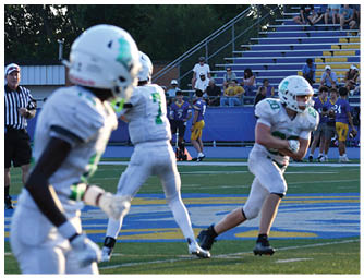 A group of football players on a field. Description generated by AI