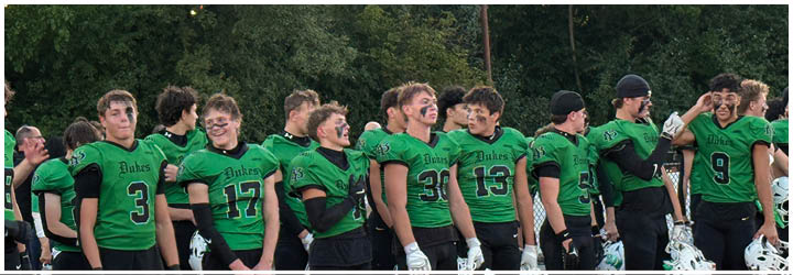 A group of football players on a field. Description generated by AI