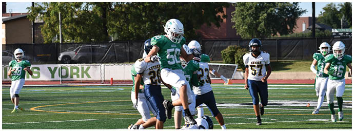 A football player wearing a blue and white uniform. Description generated by AI