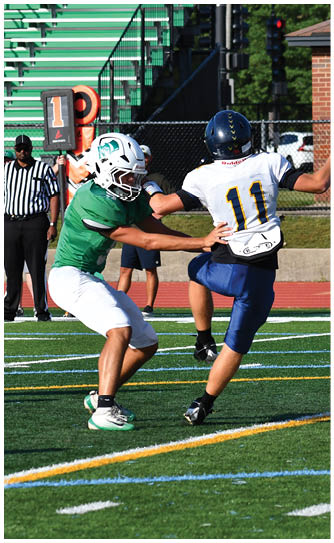 A football player catching a ball. Description generated by AI