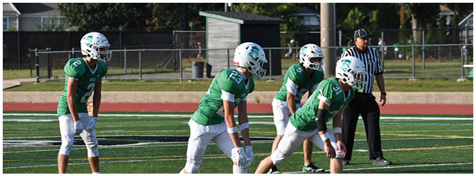 A football player wearing a blue and white uniform. Description generated by AI