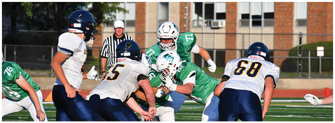 A football player wearing a blue and white uniform. Description generated by AI