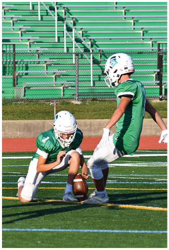 A football game is being played on a field. Description generated by AI