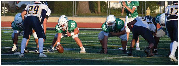 A football player wearing a blue and white uniform. Description generated by AI