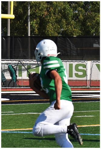 A football game is being played on a field. Description generated by AI