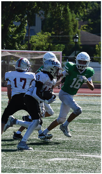 A group of football players on a field. Description generated by AI