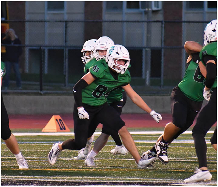 A group of football players on a field. Description generated by AI