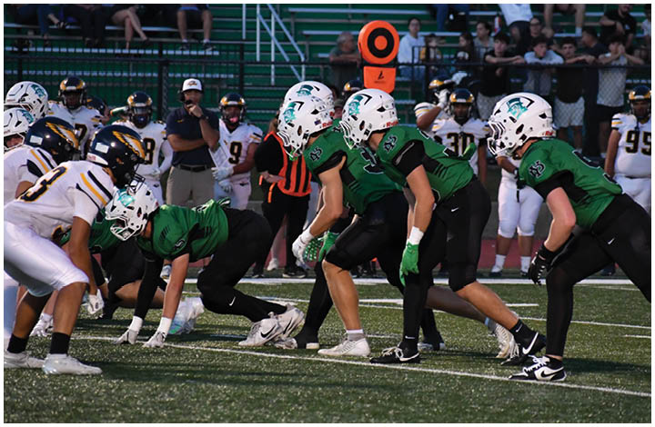 A group of football players on a field. Description generated by AI