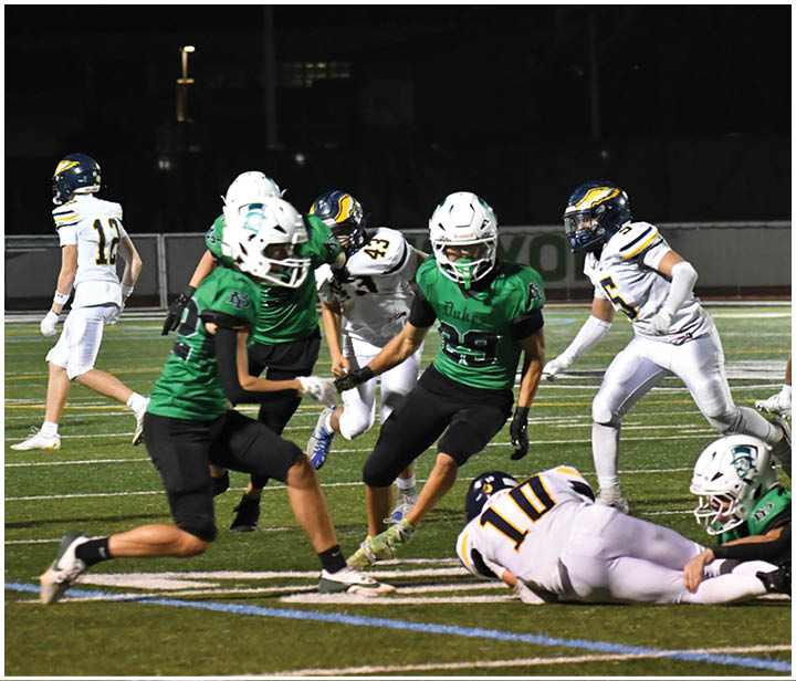 A group of football players on a field. Description generated by AI