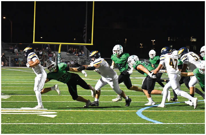 A group of football players on a field. Description generated by AI