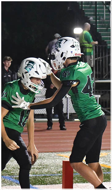 A group of football players on a field. Description generated by AI