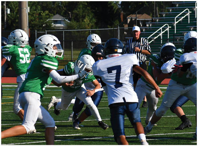 A football player wearing a blue and white uniform. Description generated by AI