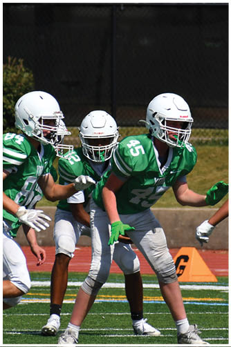 A football player catching a ball. Description generated by AI