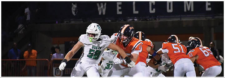 A group of football players on a field. Description generated by AI