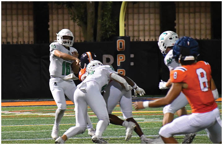 A group of football players on a field. Description generated by AI