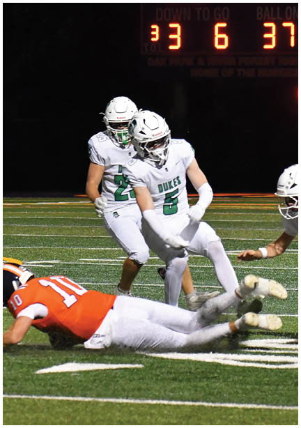 A football game is being played on a field. Description generated by AI