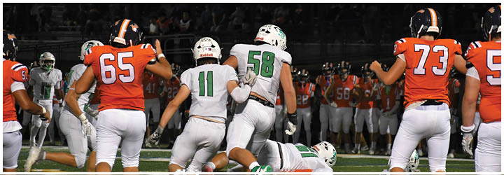 A group of football players on a field. Description generated by AI