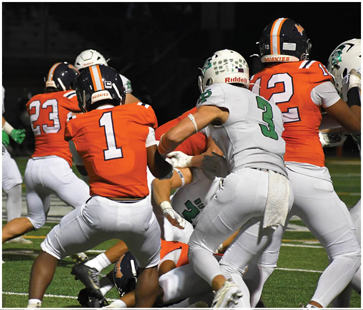 A group of football players on a field. Description generated by AI