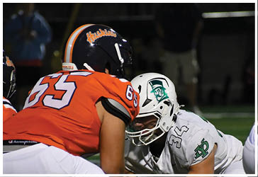Two football players celebrating on the field. Description generated by AI