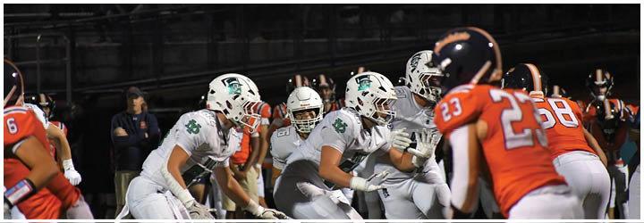 A group of football players on a field. Description generated by AI